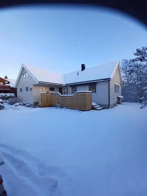 a house with snow on the ground in front of it at Ski WM Trondheim in Melhus