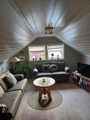 a living room with a couch and a table at Ski WM Trondheim in Melhus