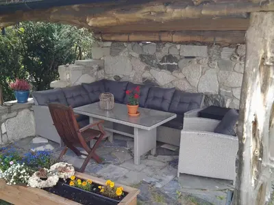 a patio with a table and a couch at Ski WM Trondheim in Melhus