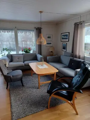 a living room with a couch and a table at Ski WM Trondheim in Melhus