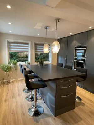 a kitchen with a large island with black counter top at Villa 10 min walk from Ski World Championship in Trondheim