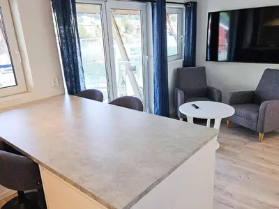 a room with a counter with chairs and a table at 4 person holiday home in Sørbøvåg in Sørbø
