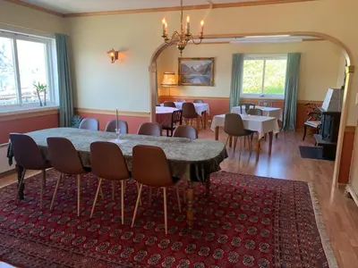 a dining room with a table and chairs at Sognefjord Gjesteheim in Vangsnes