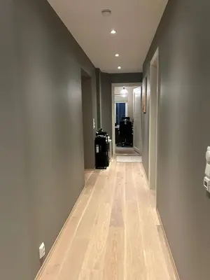 an empty hallway with wood floors in a house at Singsaker Panorama in Trondheim