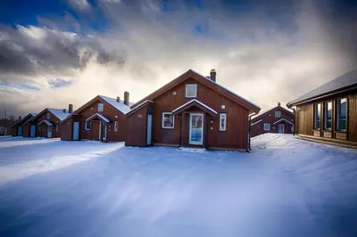 a large wooden house in the snow with snow covered ground at Perfect Base For Skiing And Local Events in Beitostøl