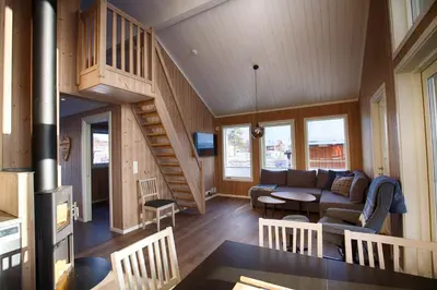 a living room with a couch and a staircase at Perfect Base For Skiing And Local Events in Beitostøl
