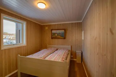 a small bedroom with a bed in a room with a window at Perfect Base For Skiing And Local Events in Beitostøl