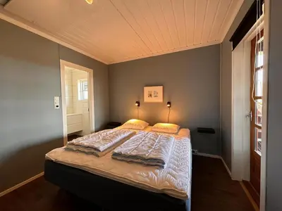 a bedroom with a large bed in a room at Mountain Home With 5 Bedrooms And 2 Fireplaces in Beitostøl
