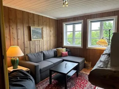 a living room with a couch and a table at Mountain Home With 5 Bedrooms And 2 Fireplaces in Beitostøl