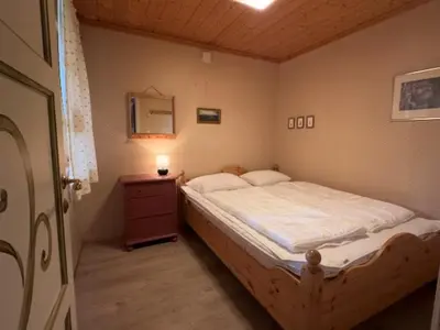 a bedroom with a bed and a dresser with a mirror at Mountain Home With 5 Bedrooms And 2 Fireplaces in Beitostøl
