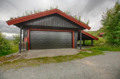 a garage with a large door in front of it at Mountain Home With 5 Bedrooms And 2 Fireplaces in Beitostøl