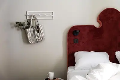 a bedroom with a bed with a red headboard at VANDER Altona in Bergen