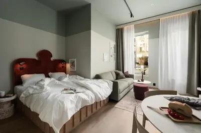 a bedroom with a large bed and a couch at VANDER Altona in Bergen