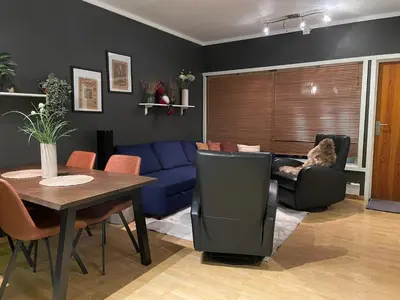 a living room with a blue couch and a table at Geilo sentrumsnær leilighet in Geilo