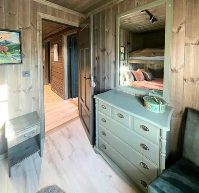 a bedroom with a bed and a dresser with a mirror at Family Cabin With Ski-Inski-Out In Trysil in Trysil