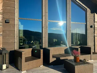 a balcony with two chairs and a large window at Family Cabin With Ski-Inski-Out In Trysil in Trysil