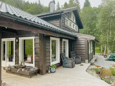 a log cabin with a porch and a patio at Cozy Modern Cabin In West Norway With View in Davik