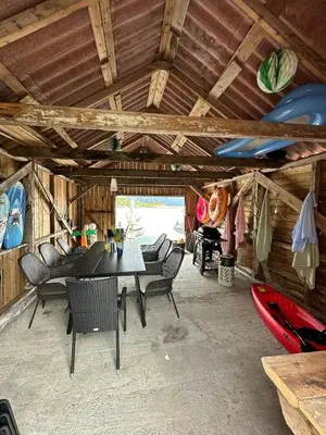 a dining room with a table and chairs in a cabin at Idyllic Cabin At Bømlafjorden With Sea View in Mosterhamn