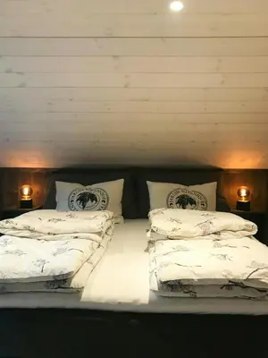 a large bed with two pillows on top of it at Large Cabin Near Hardangervidda With Sunny Veranda in Veggli