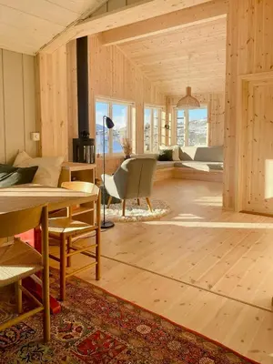 a living room with wooden walls and a table and chairs at Cosy Holiday Home With Stunning Views In Rauland in Rauland