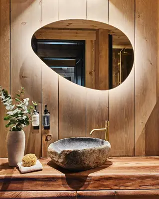 a bathroom with a stone sink and a mirror at Luxury Cabin With Views in Stranda