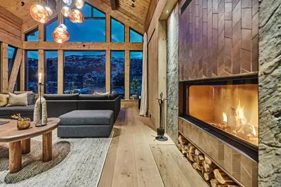 a living room with a fireplace in a house at Luxury Cabin With Views in Stranda