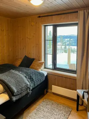 a bedroom with a bed and a large window at Modern Cabin With Beautiful Design By Gålåvatn in Gålå