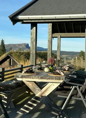 a picnic table on the deck of a house at Modern Cabin With Views Of Skeikampen in Svingvoll