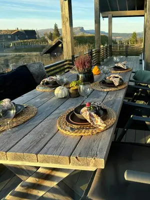 a wooden table with plates of food on it at Modern Cabin With Views Of Skeikampen in Svingvoll
