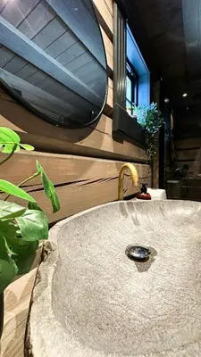 a sink in a bathroom with a window and a mirror at Cozy Log Cabin With A View Over Hedmarken in Løten
