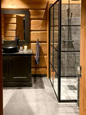 a bathroom with a sink and a glass shower at Luxury Log Cabin By Hardangervidda in Uvdal