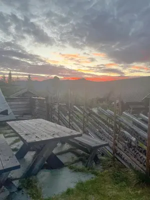 a picnic table with a view of the mountains at Luxury Log Cabin By Hardangervidda in Uvdal