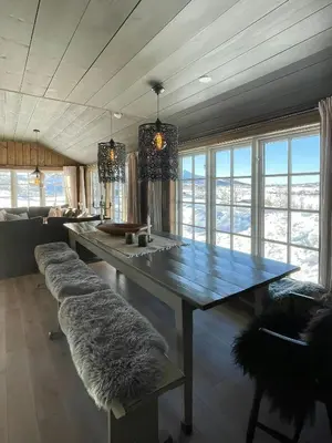 a living room with a large table and a couch at Secluded Mountain Cabin In Rauland With View in Rauland