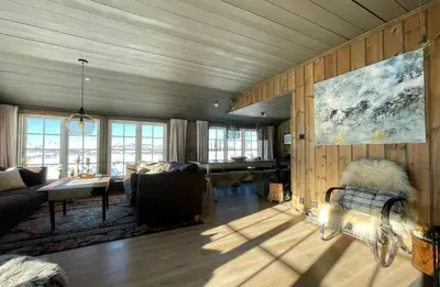 a living room with a couch and a table at Secluded Mountain Cabin In Rauland With View in Rauland