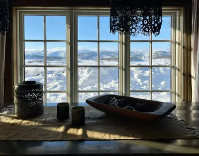 a window with a bowl on a table with snow at Secluded Mountain Cabin In Rauland With View in Rauland