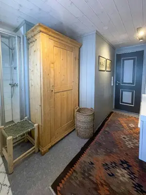 a room with a large wooden cabinet and a basket at Secluded Mountain Cabin In Rauland With View in Rauland