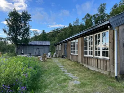 a wooden building with windows and a picnic table at Secluded Mountain Cabin In Rauland With View in Rauland