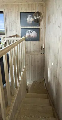 a staircase in a room with wood paneling at Norefjell Cottage With Sauna And Whirlpool in Noresund