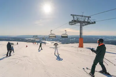 a group of people skiing on a ski lift at Norefjell Cottage With Sauna And Whirlpool in Noresund