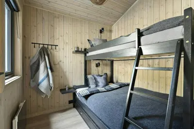 a room with two bunk beds in a cabin at Norefjell Cottage With Sauna And Whirlpool in Noresund