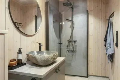 a bathroom with a bowl sink and a shower at Norefjell Cottage With Sauna And Whirlpool in Noresund