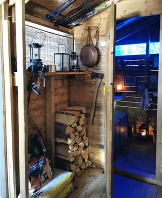 an outside view of a cabin with a pile of wood at Ål Cabin With Panoramic Views in Favang