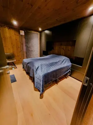 a bedroom with a bed and a chair in a room at Luxury Mountain Home With View On Gaustablikk in Rjukan