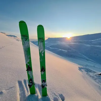 a pair of skis in the snow at sunset at Luxury Mountain Home With View On Gaustablikk in Rjukan