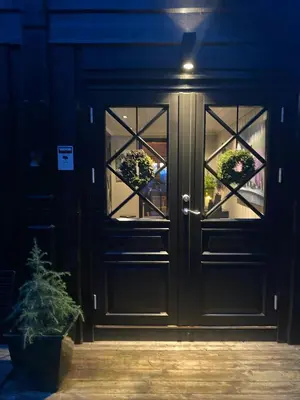 a black door with potted plants on it at Authentic Cabin Hygge All Year Round At Hafjell in Øyer