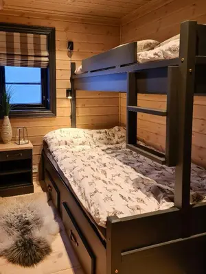a bedroom with a bunk bed and a window at Modern Cabin With Ski Inout In Great Area in Brunstad