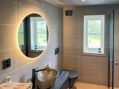 a bathroom with a sink and a mirror at Modern Cabin By Hardangervidda in Garden