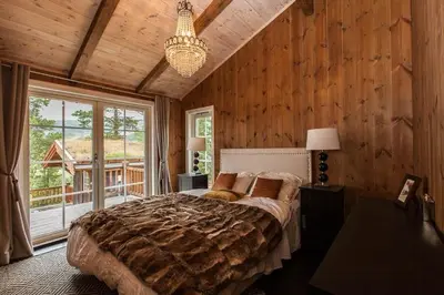 a bedroom with a large bed and a large window at Cozy Cabin In Uvdal With Jacuzzi And Sauna in Uvdal