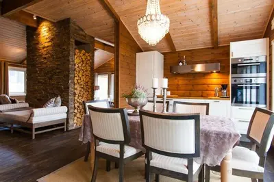 a kitchen and dining room with a table and chairs at Cozy Cabin In Uvdal With Jacuzzi And Sauna in Uvdal