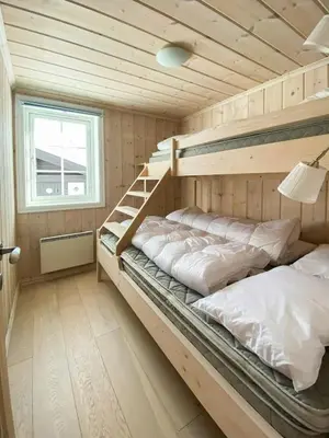 a bedroom with two bunk beds and a window at Relax By The Ski Tracks In A Cabin At Sjusjøen in Sjusjøen